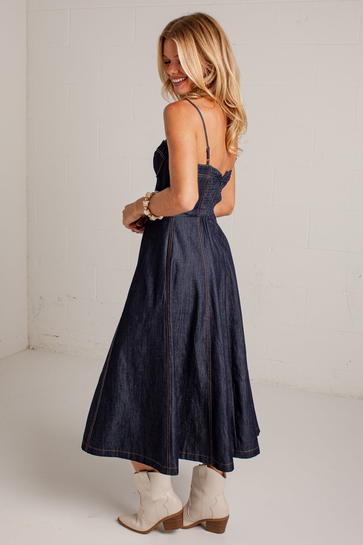 dark-wash dress features a strapless bustier-inspired bodice with defined seaming and a flattering fitted silhouette