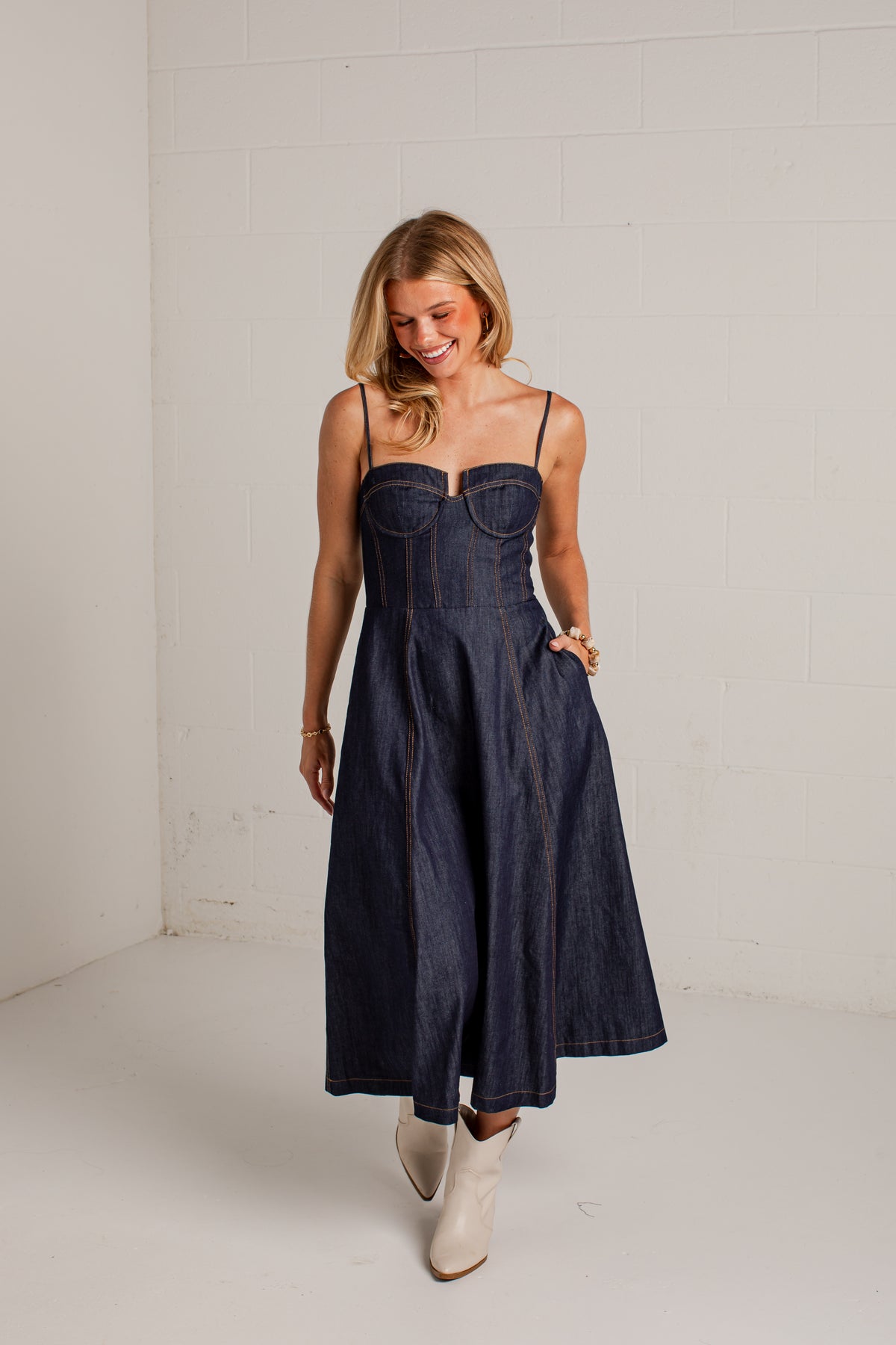 dark-wash dress features a strapless bustier-inspired bodice with defined seaming and a flattering fitted silhouette