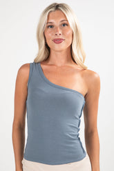 Woman wearing a blue one-shoulder top against a white background