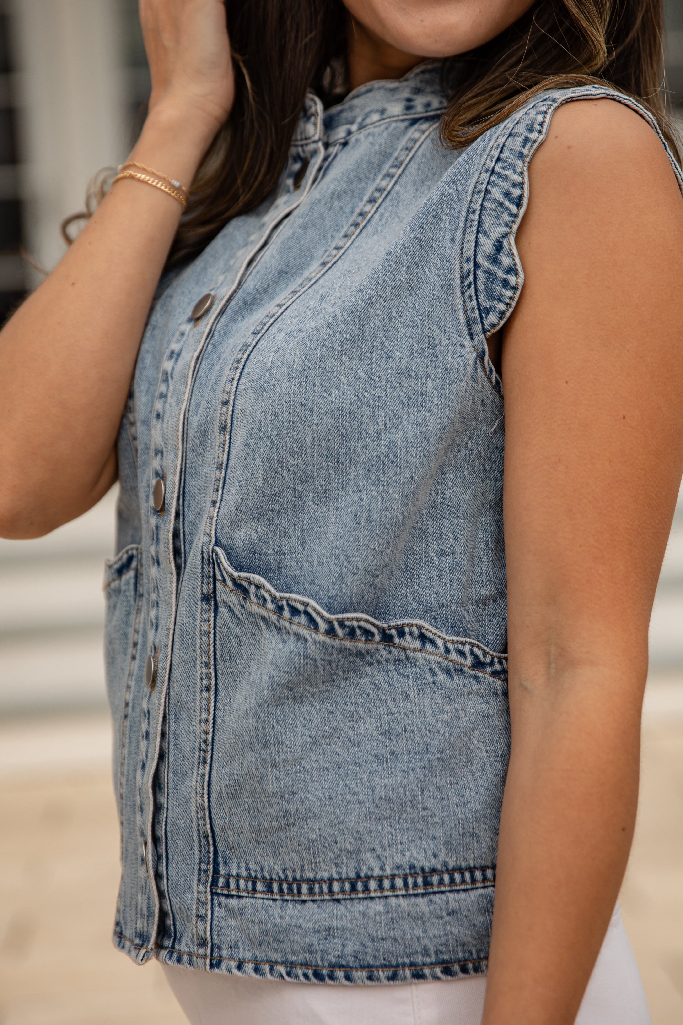 Denim vest worn by a person with a blurred background