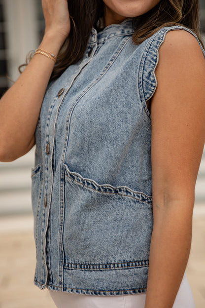 Denim vest worn by a person with a blurred background