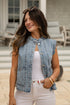 Woman wearing a denim vest and white pants outdoors