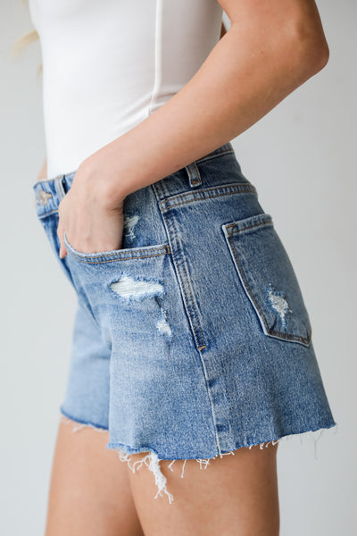 high rise Medium Wash Distressed Denim Shorts, Jordan Medium Wash Distressed Denim Shorts have a relaxed fit and high waisted. Cute raw frayed hem 
