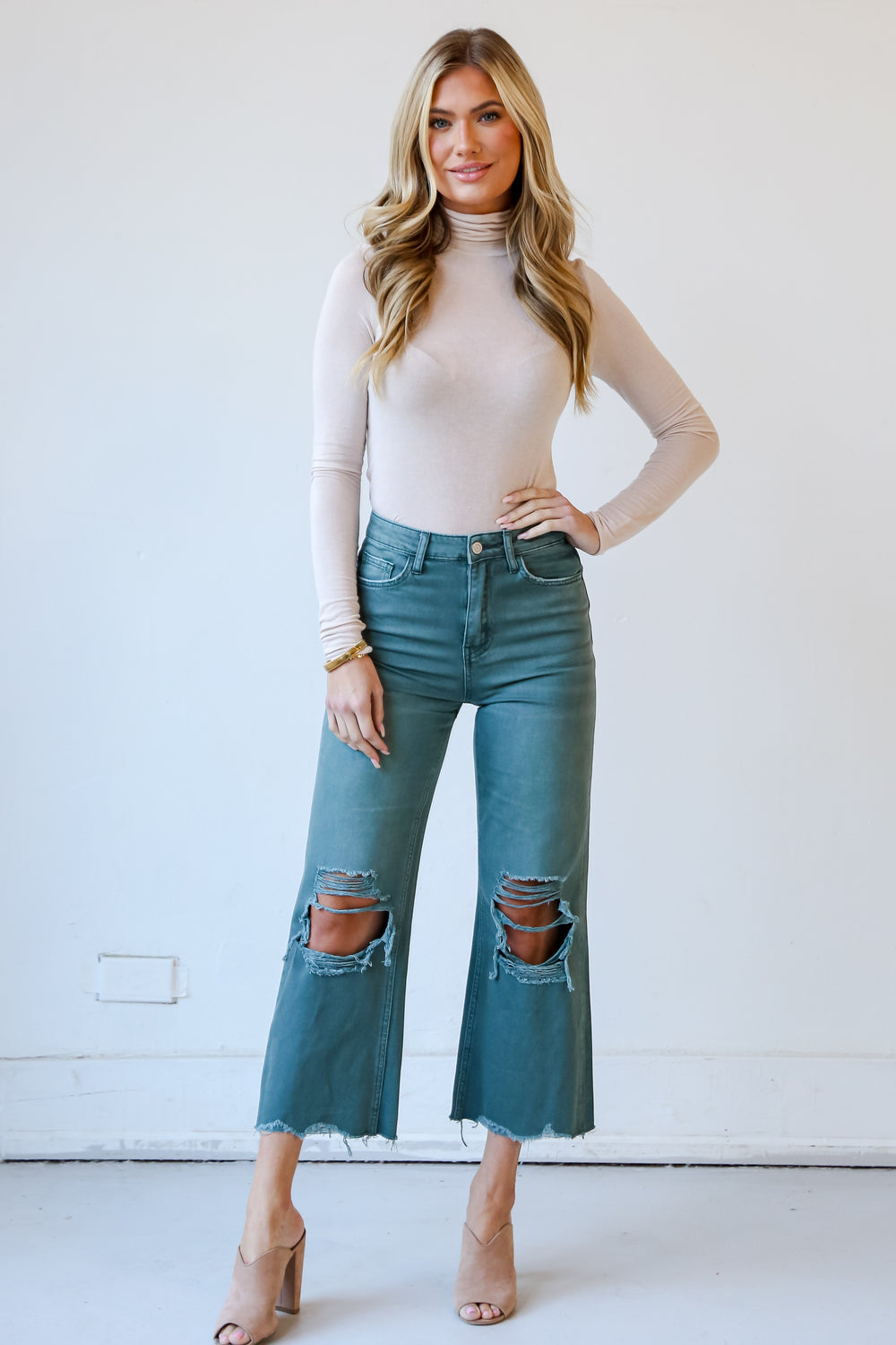 Sage Distressed Flare Jeans on model