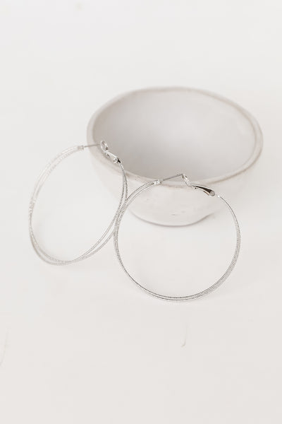 Silver Hoop Earrings flat lay