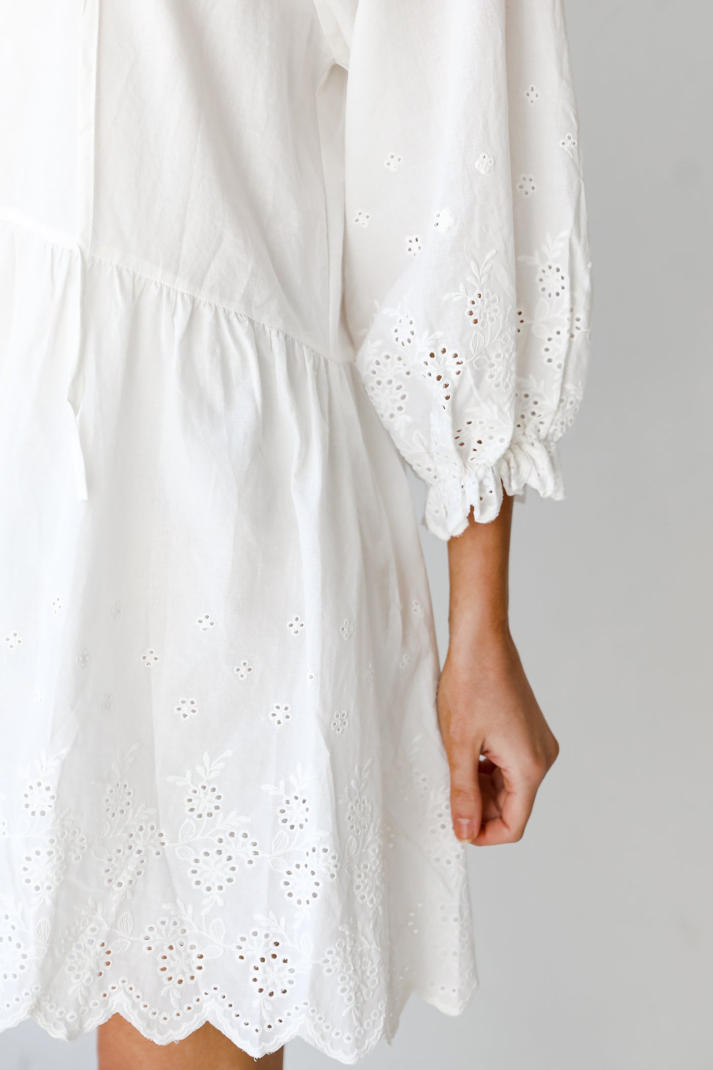 white Tiered Eyelet Mini Dress close up of sleeve
