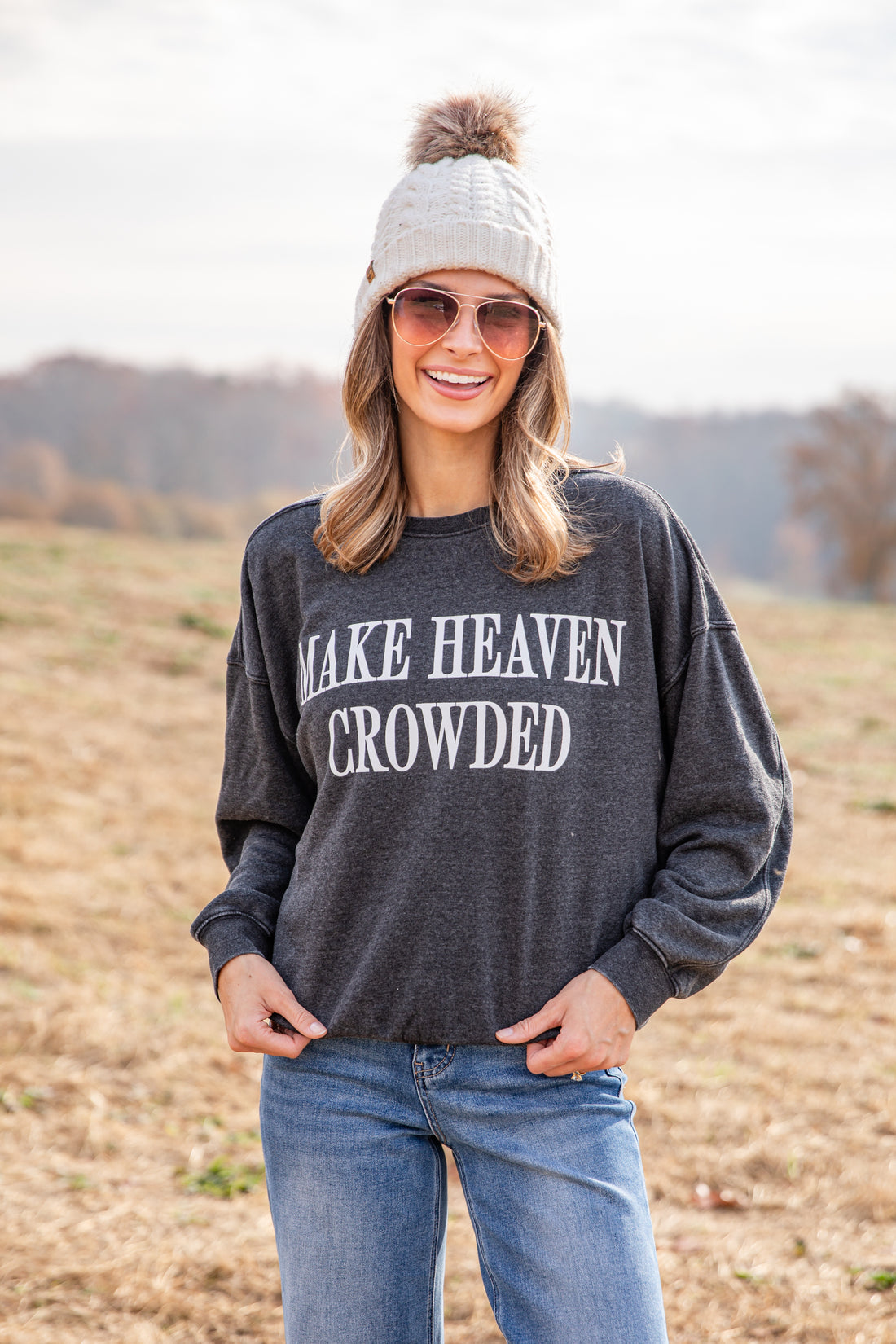 Woman wearing a dark gray sweatshirt with &