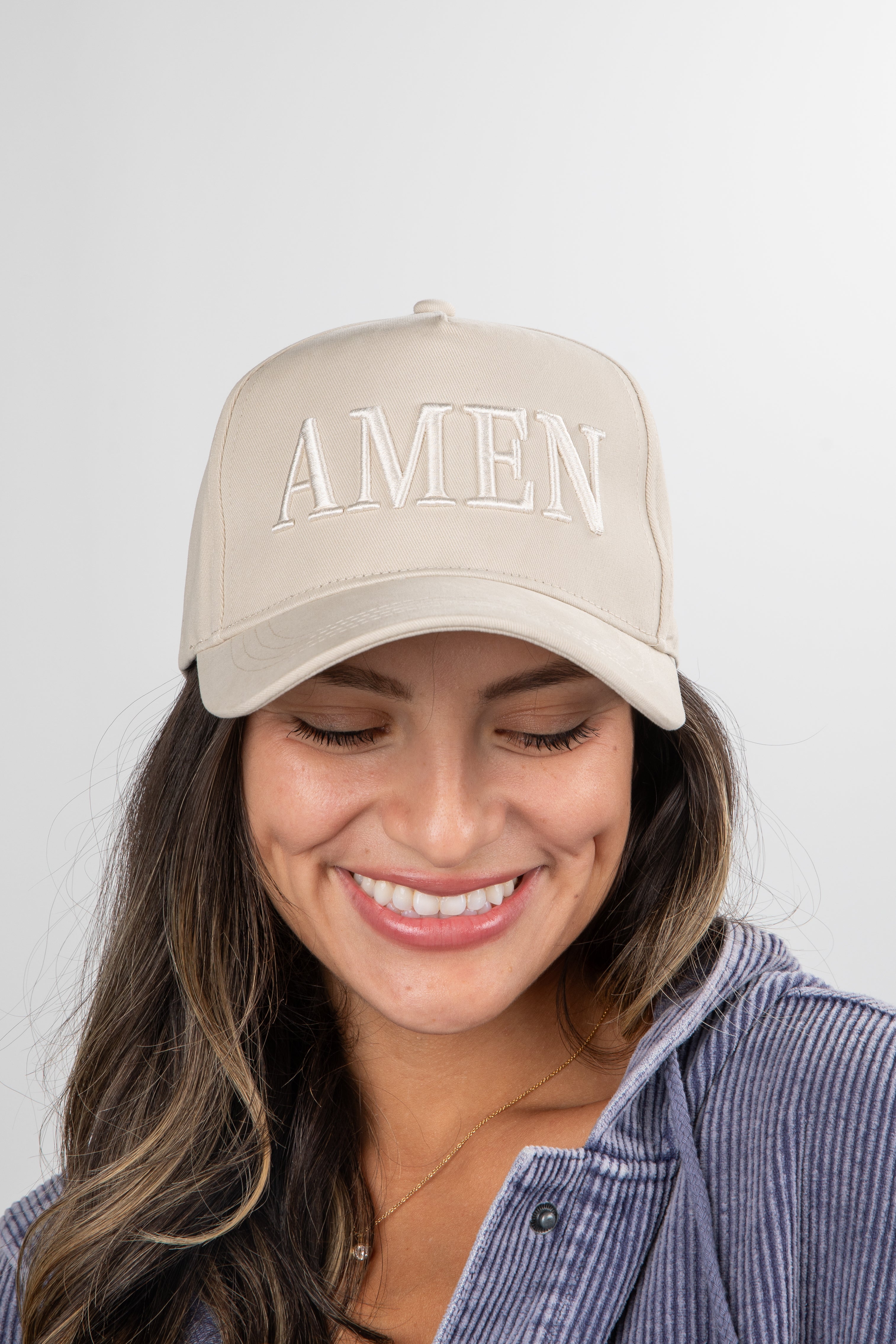 Woman wearing a beige cap with &