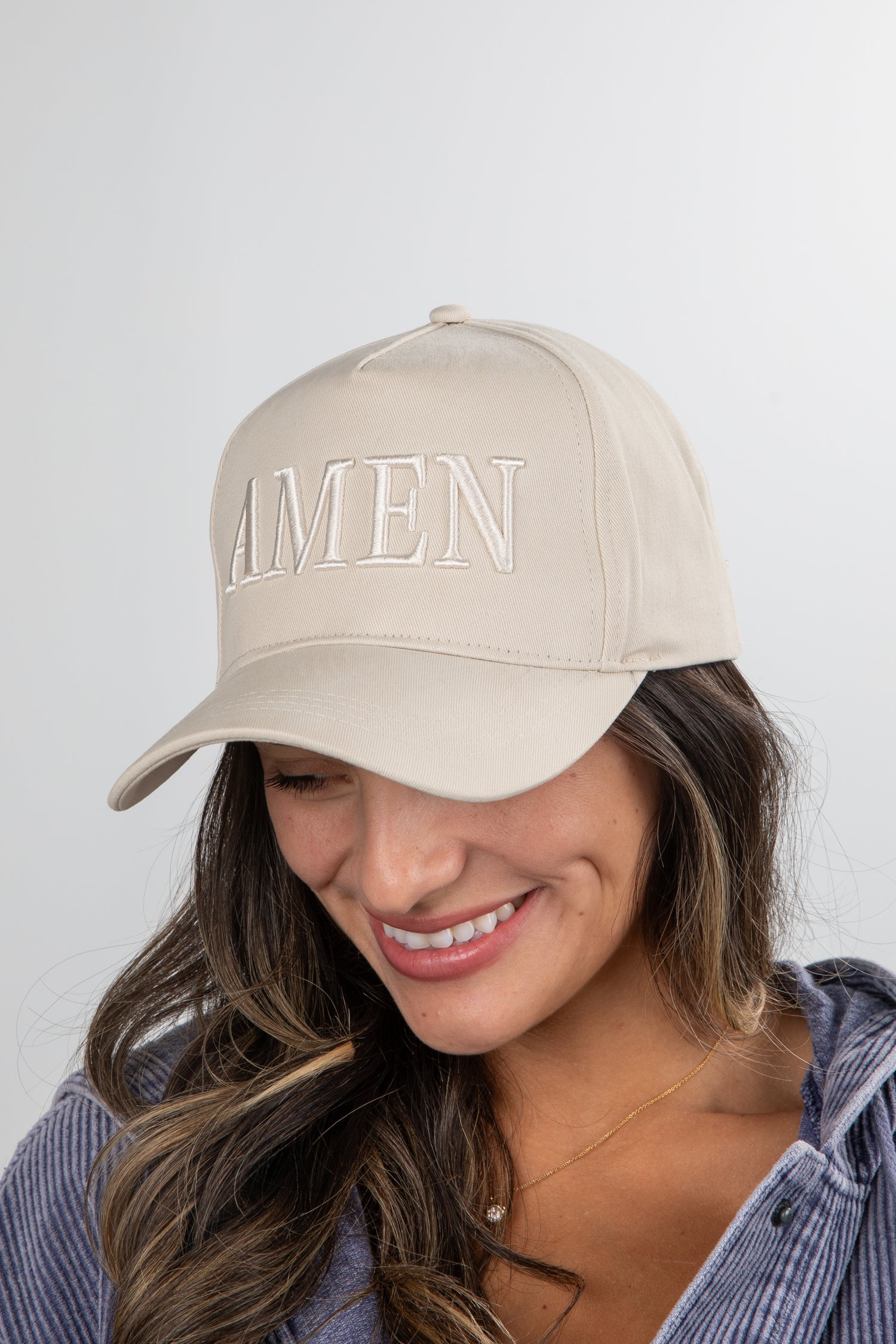 Woman wearing a beige cap with &