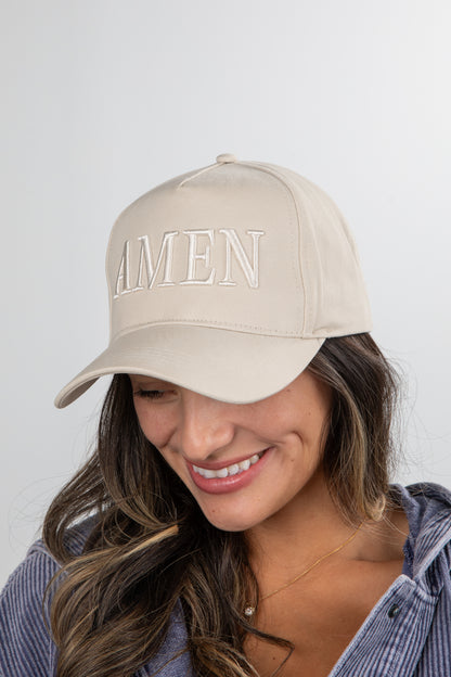 Woman wearing a beige cap with &