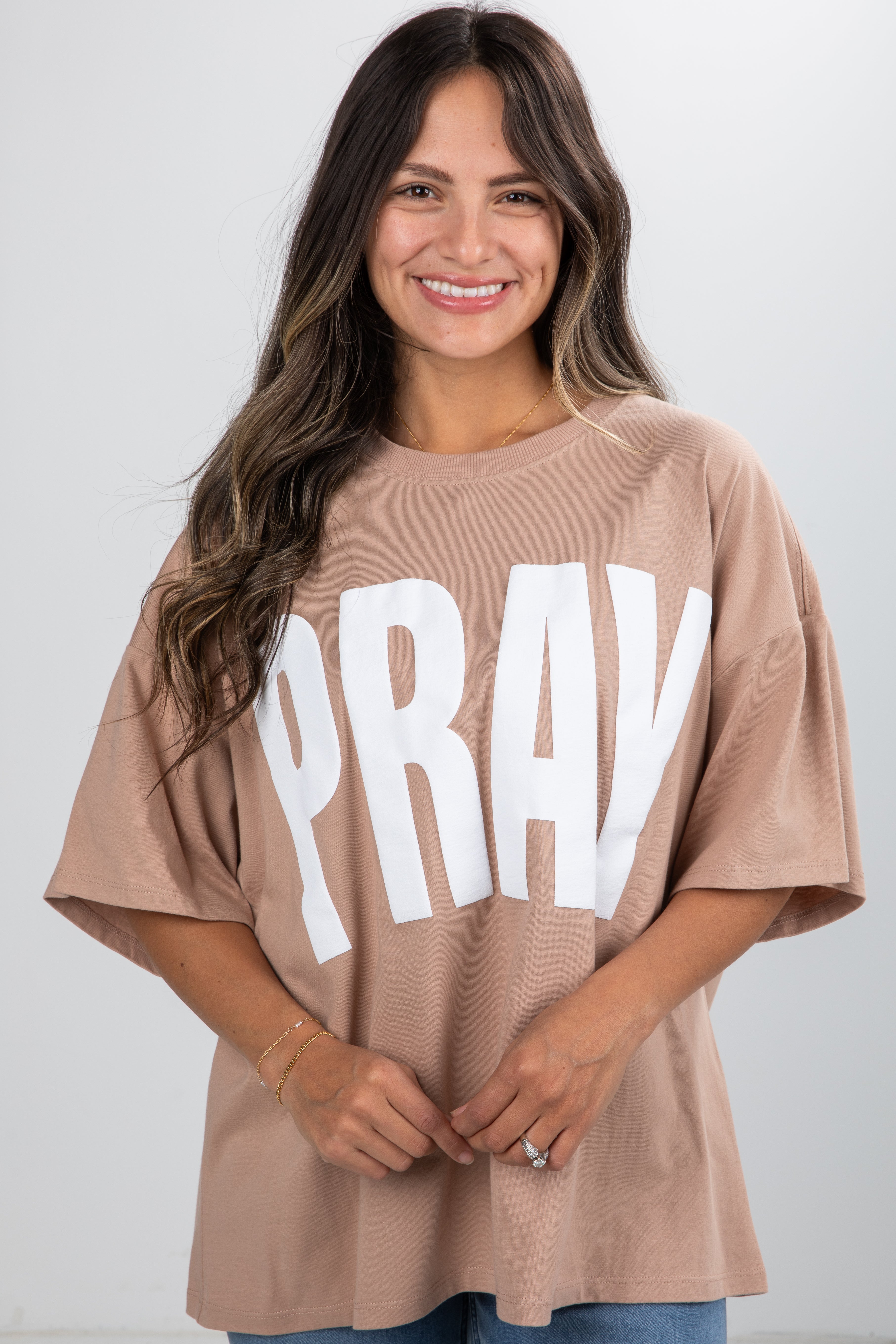 Woman wearing a beige t-shirt with &