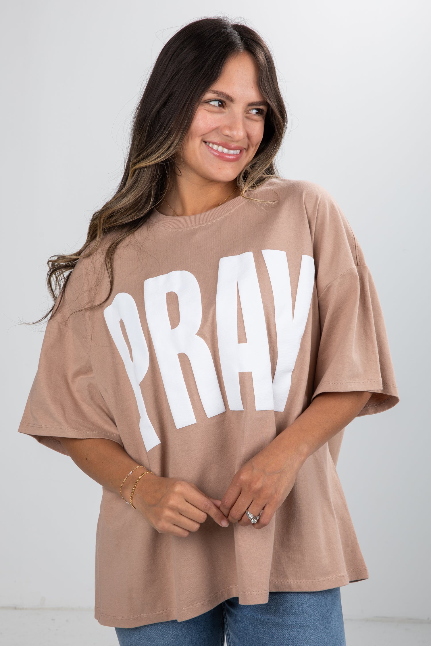 Woman wearing a beige t-shirt with &