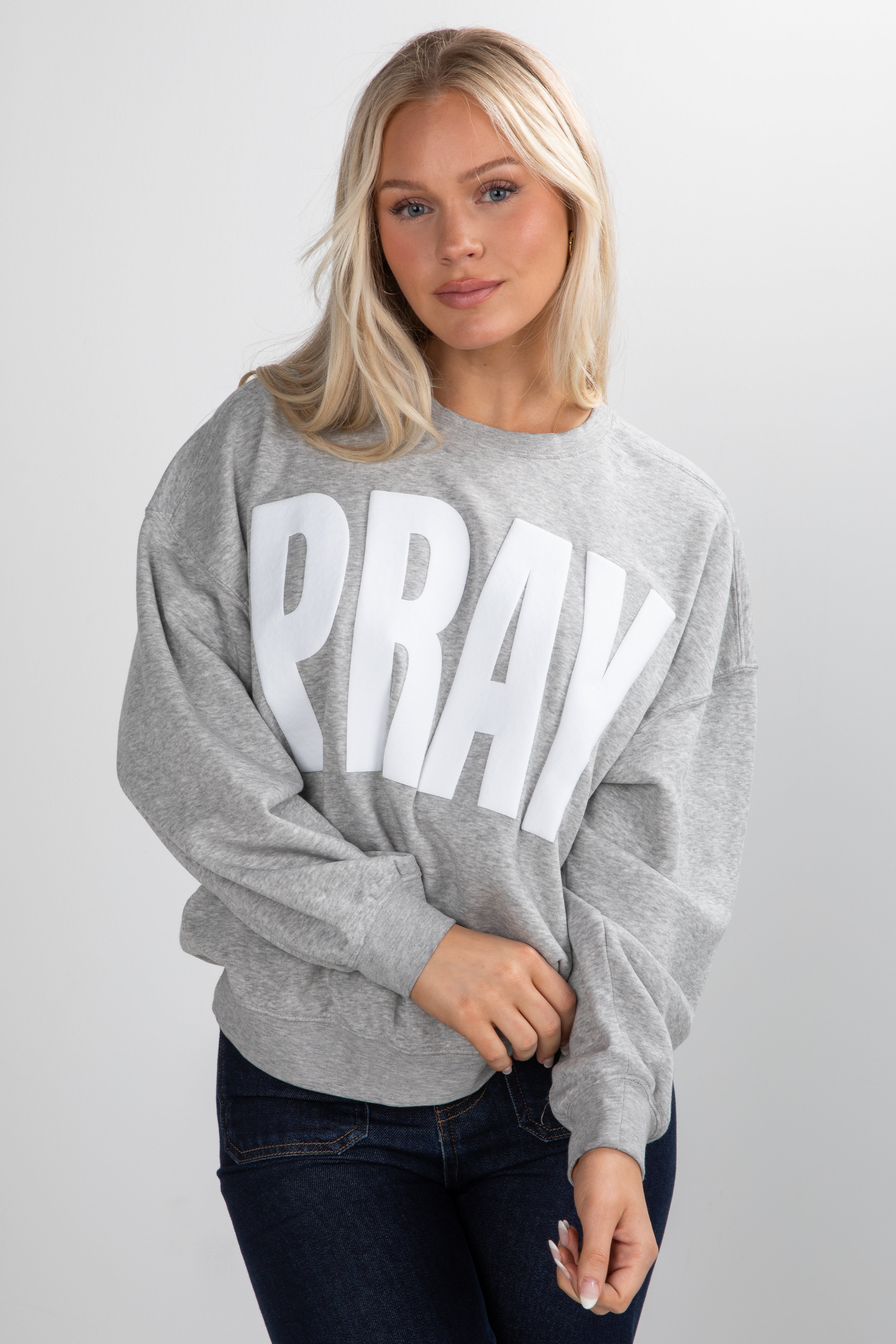 Woman wearing a gray sweatshirt with &