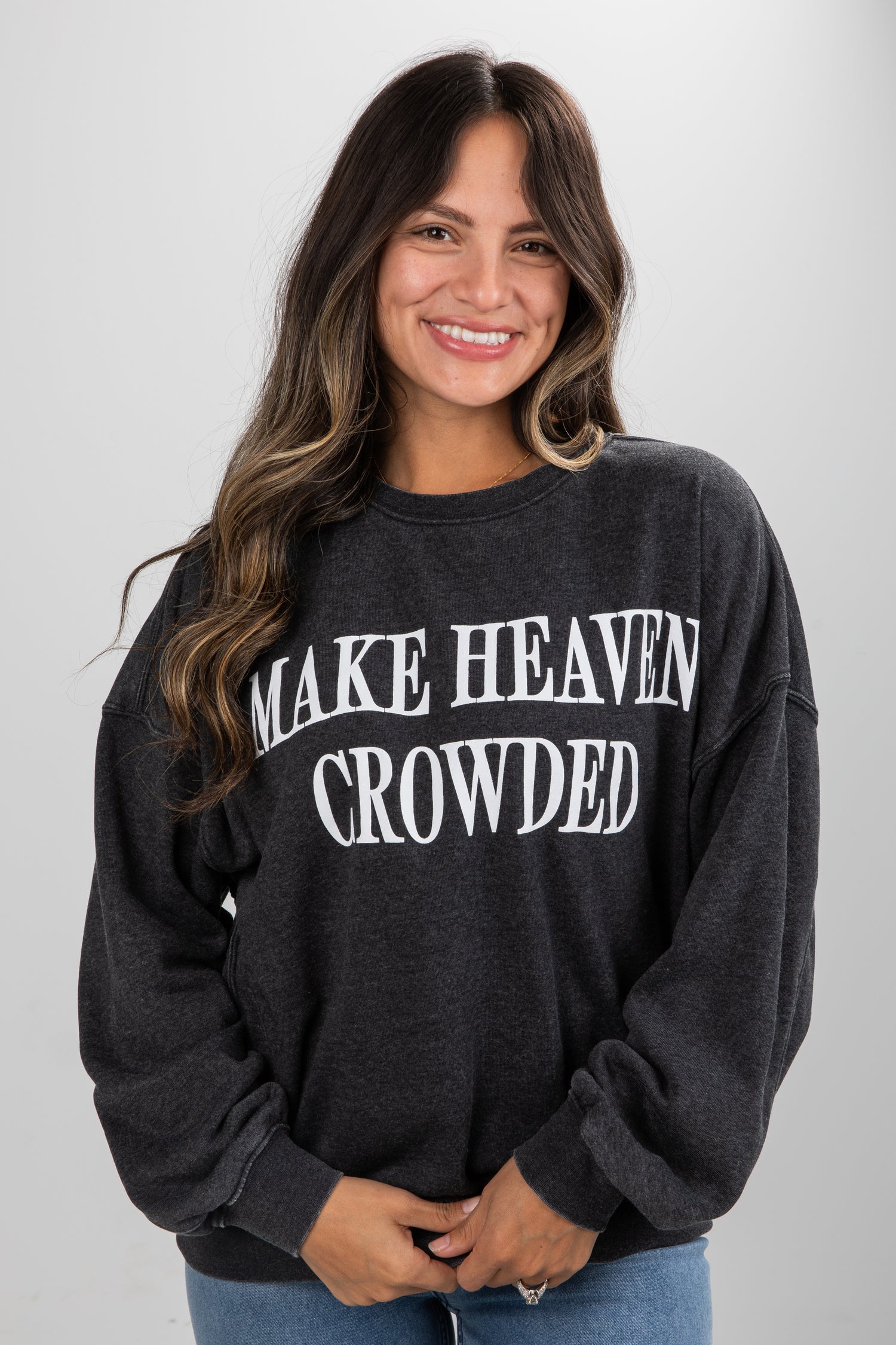 Woman wearing a black sweatshirt with &