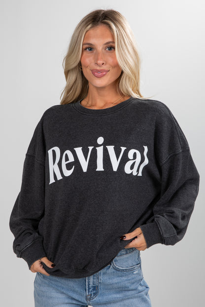 Woman wearing a black sweatshirt with &