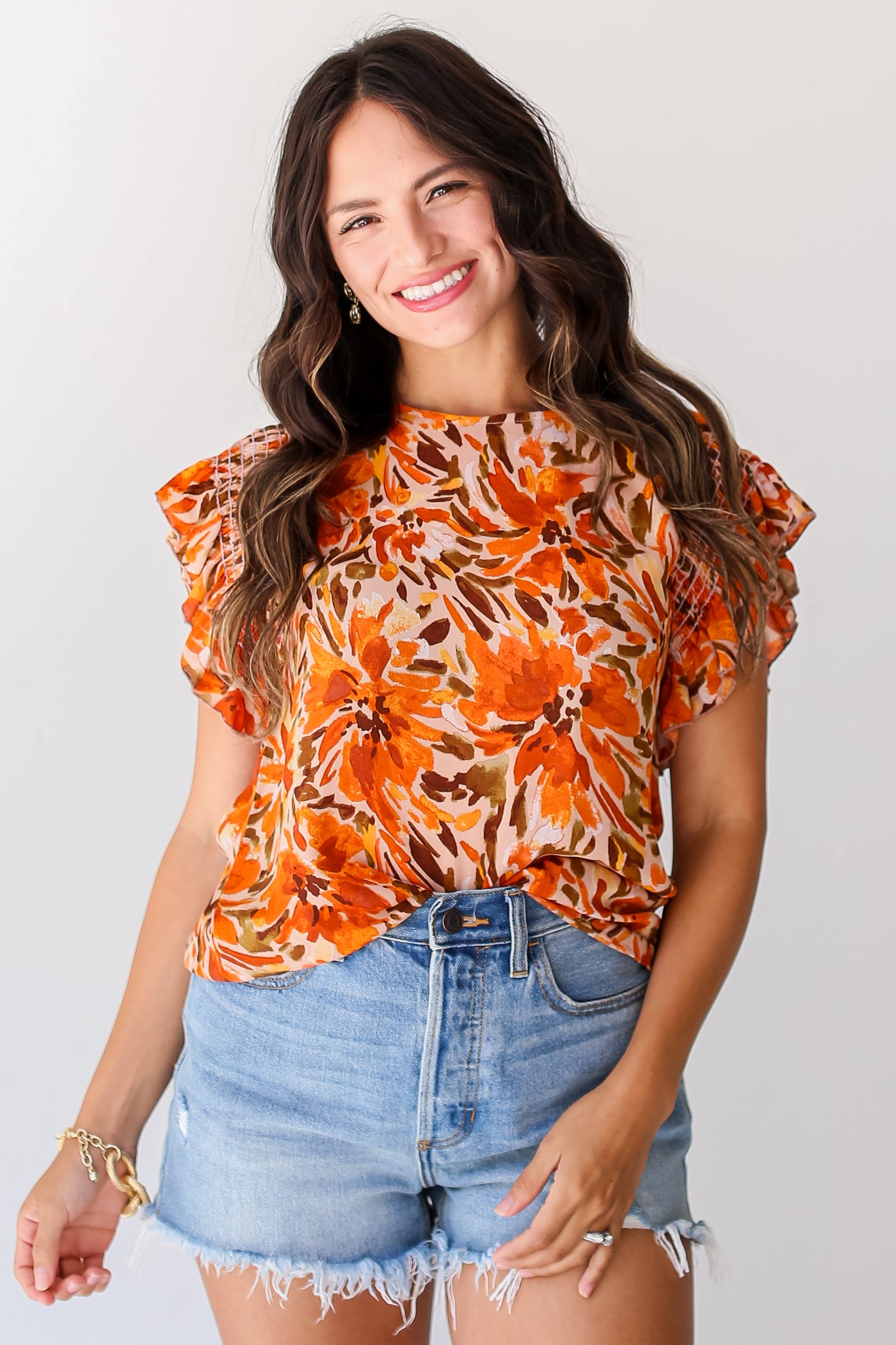 rust Floral Ruffle Sleeve Blouse with denim shorts