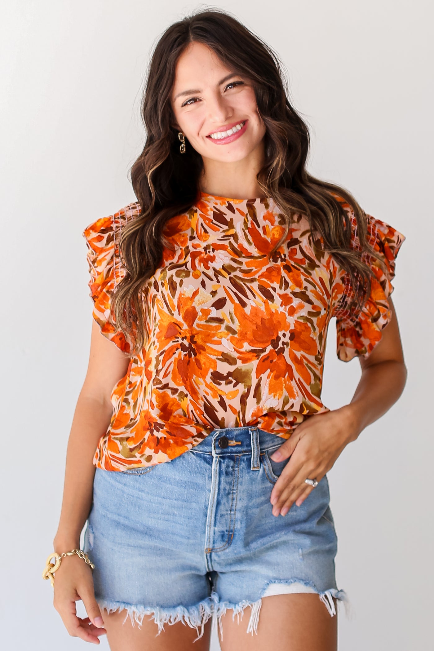 model wearing a cute rust Floral Ruffle Sleeve Blouse for fall