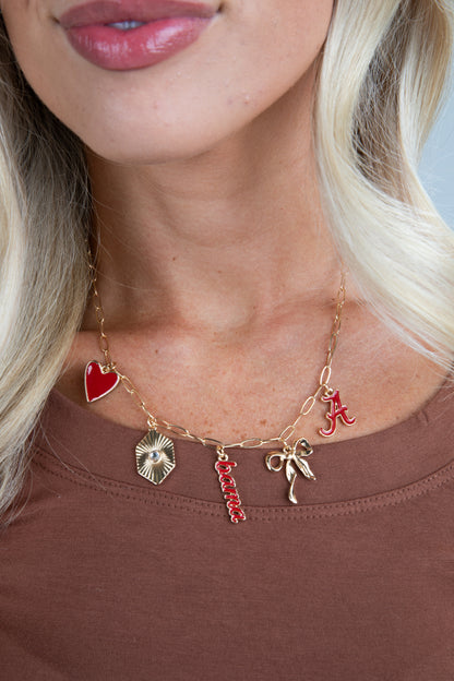 Necklace with various charms including a red heart, star, and letter &