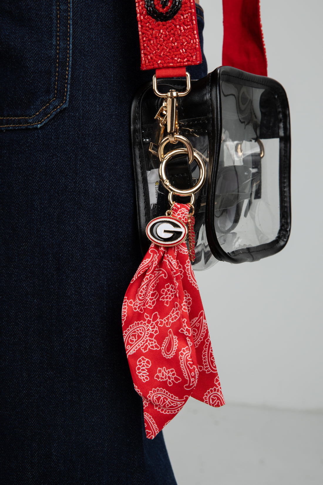 Red bandana keychain with a clear pouch on a dark background
