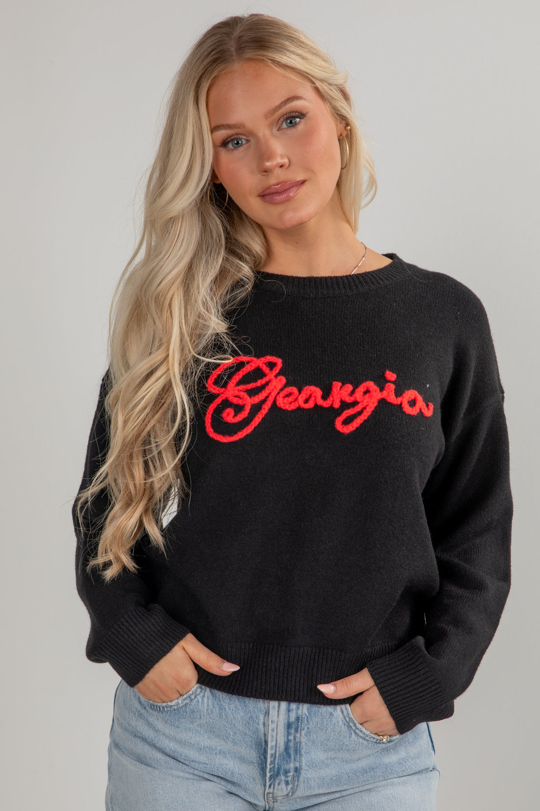 Woman wearing a black sweater with &