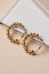 Gold hoop earrings with beaded design on a beige surface