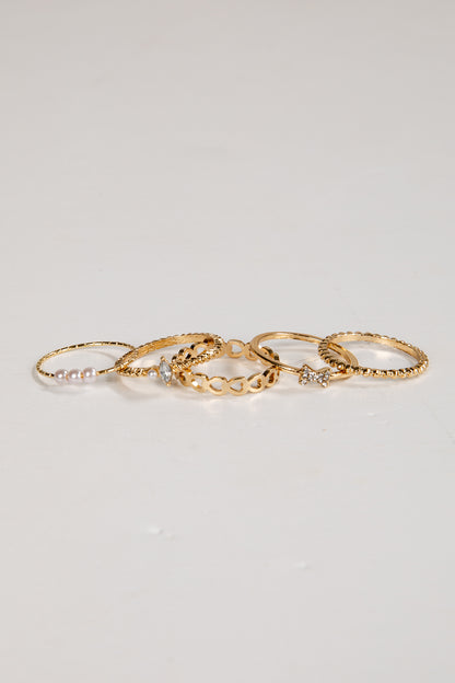 Set of gold rings on a light gray background