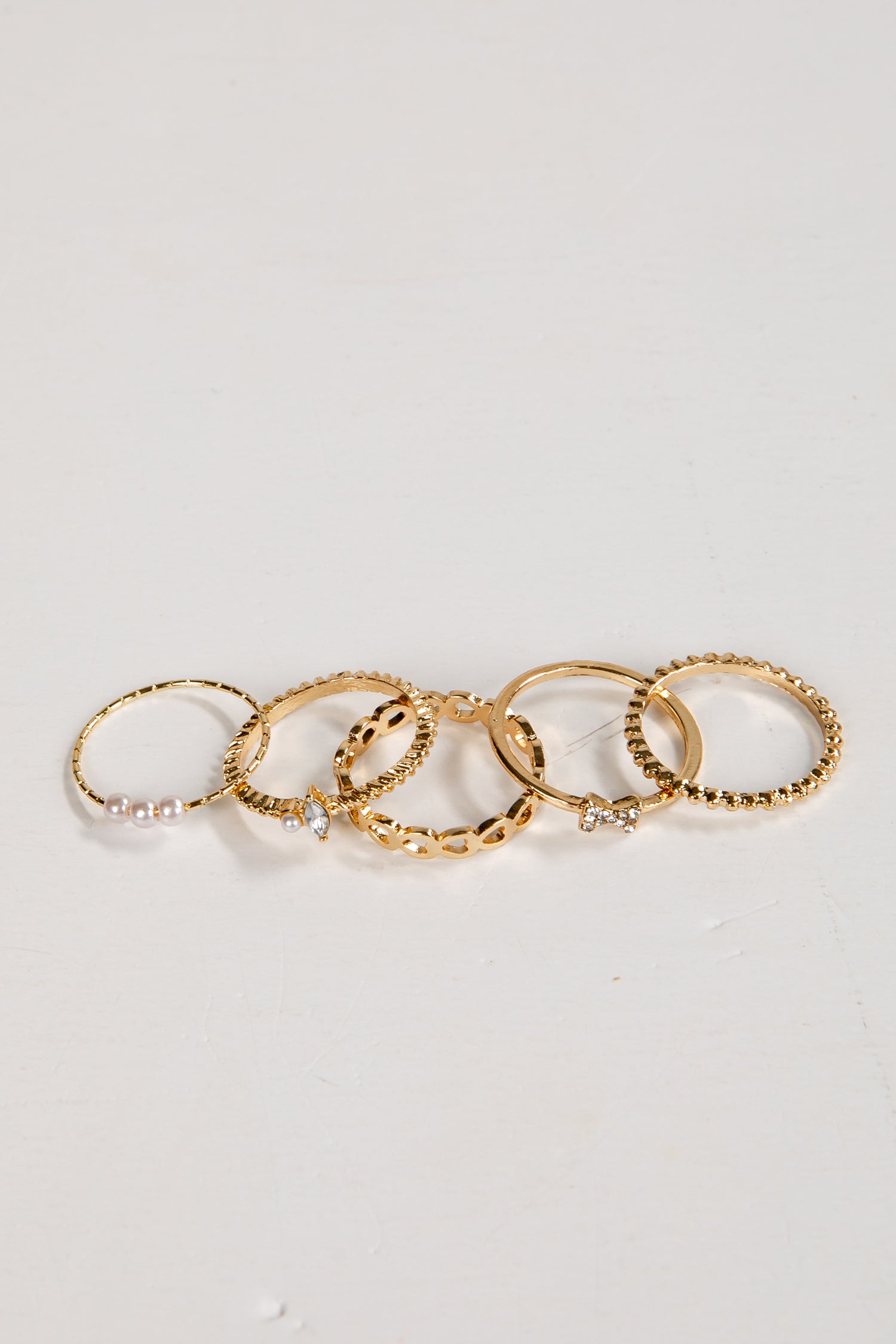 Set of gold rings on a light gray background