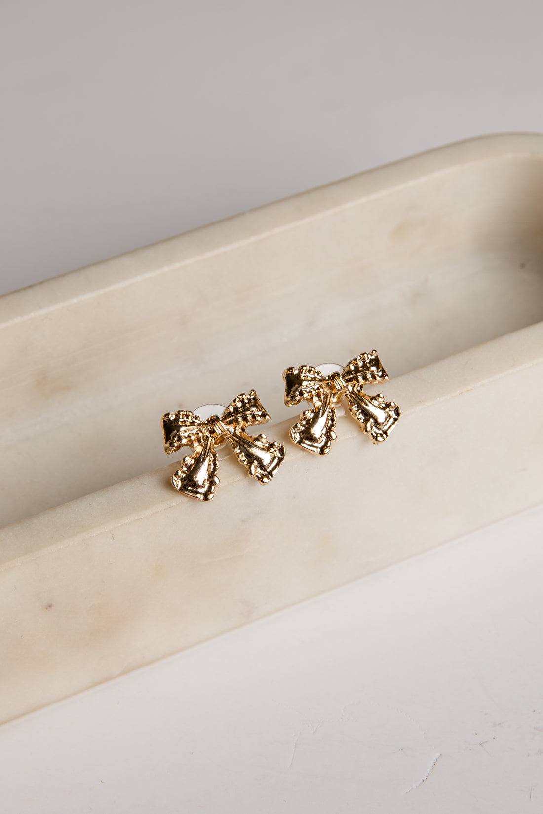 Gold bow stud earrings