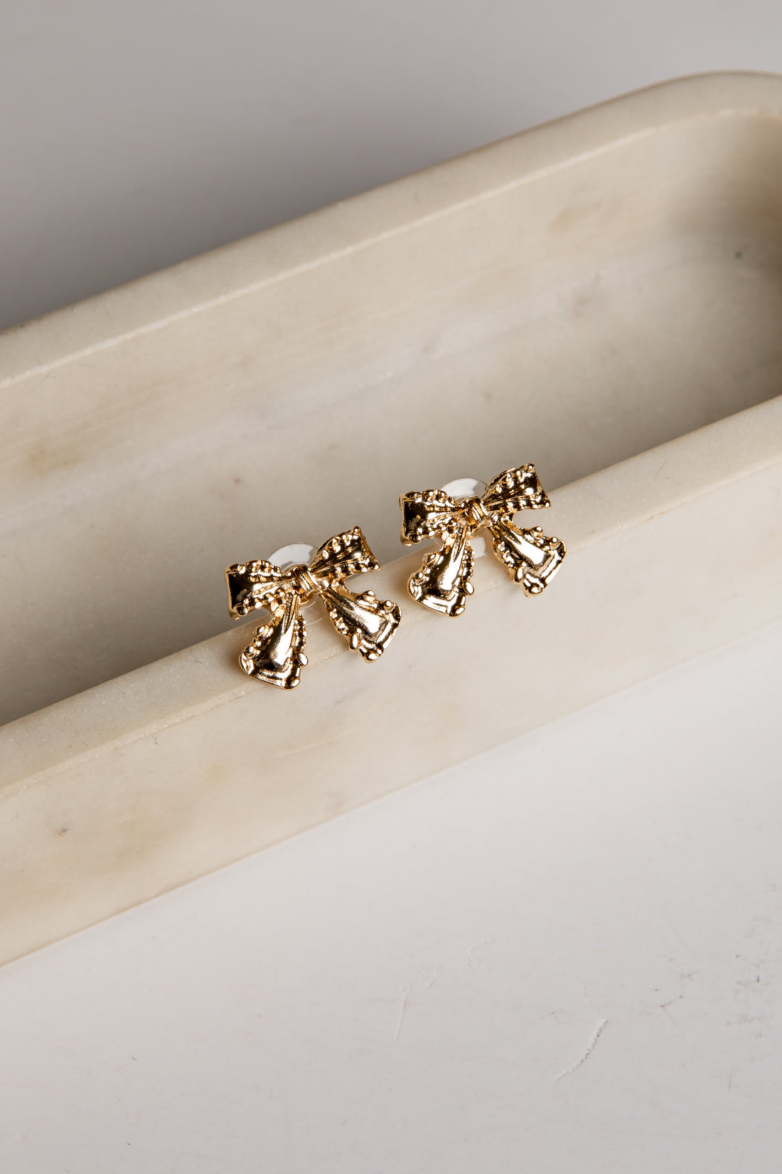 Gold bow stud earrings