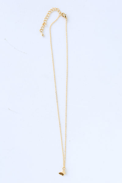 Gold Butterfly Charm Necklace flat lay