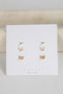 Set of butterfly-shaped earrings on a white card with &