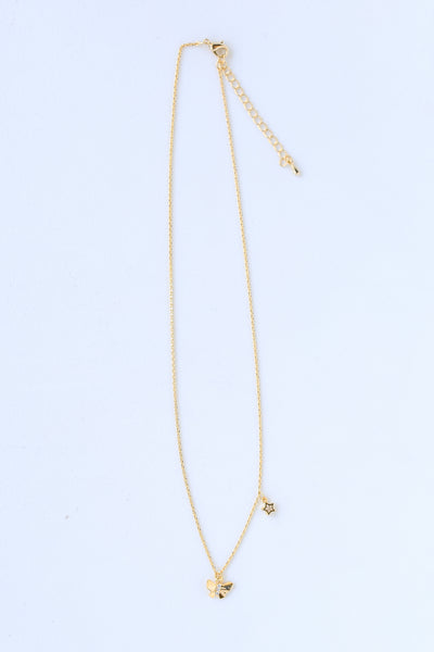 Gold Rhinestone Butterfly + Star Charm Necklace flat lay