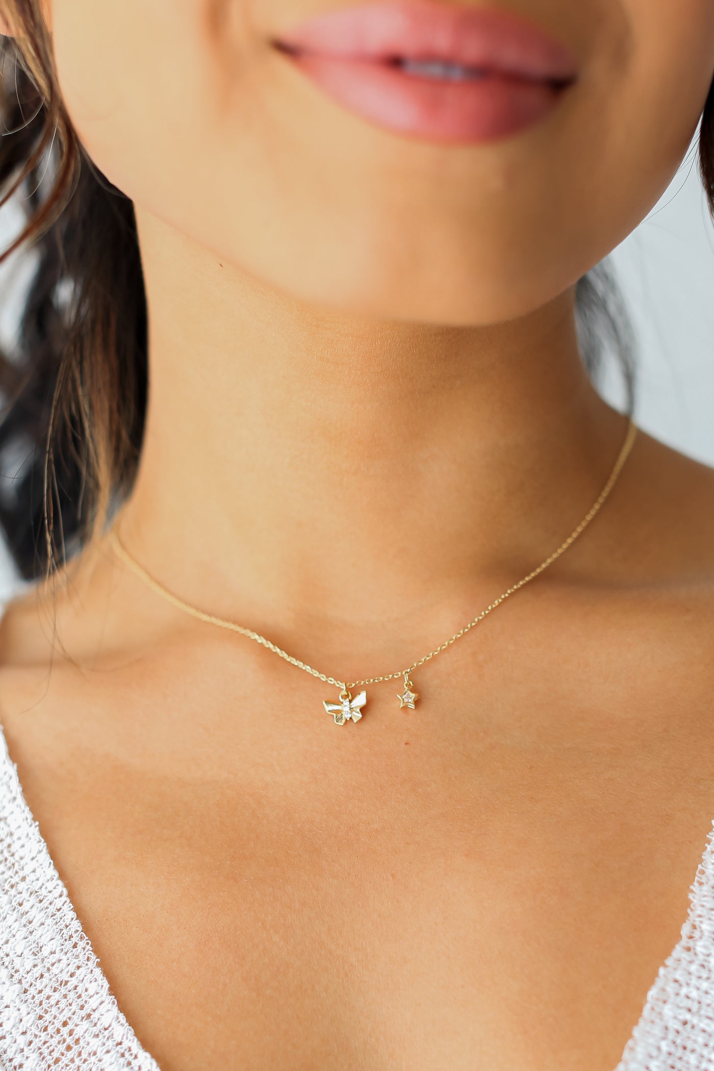Gold Rhinestone Butterfly + Star Charm Necklace on model