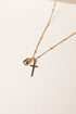 Gold necklace with a cross pendant on a white background