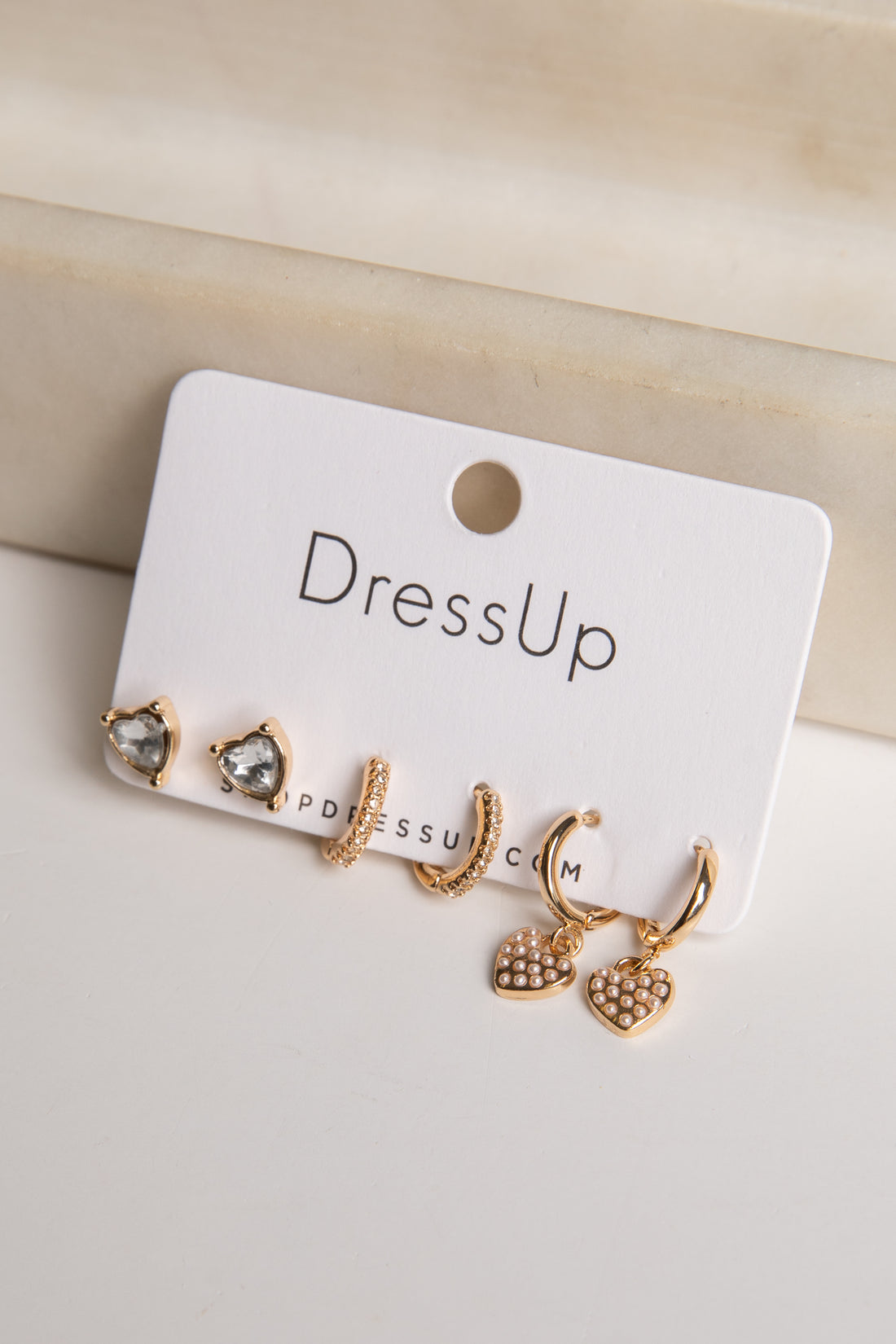 Set of gold earrings on a &