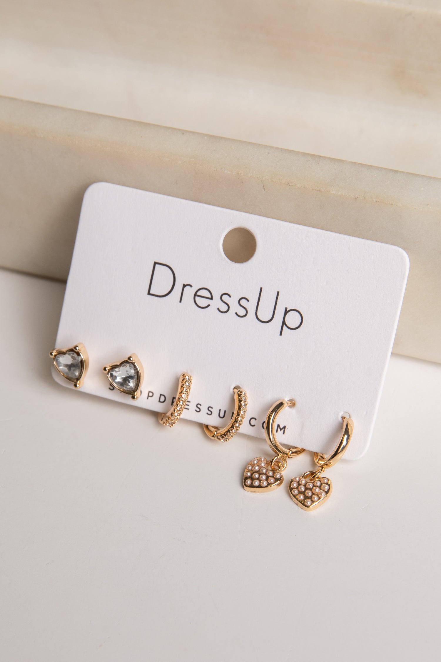 Set of gold earrings on a &