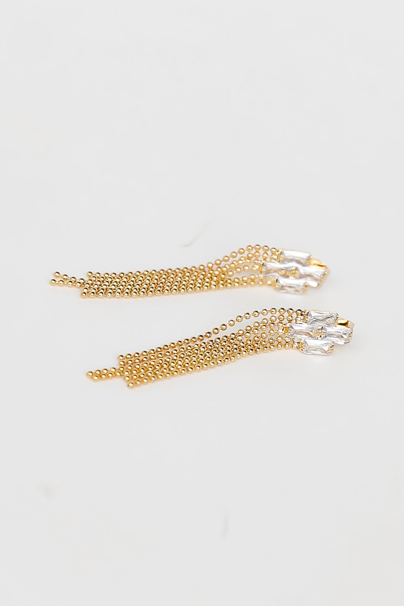 Gold Rhinestone Beaded Fringe Earrings flat lay