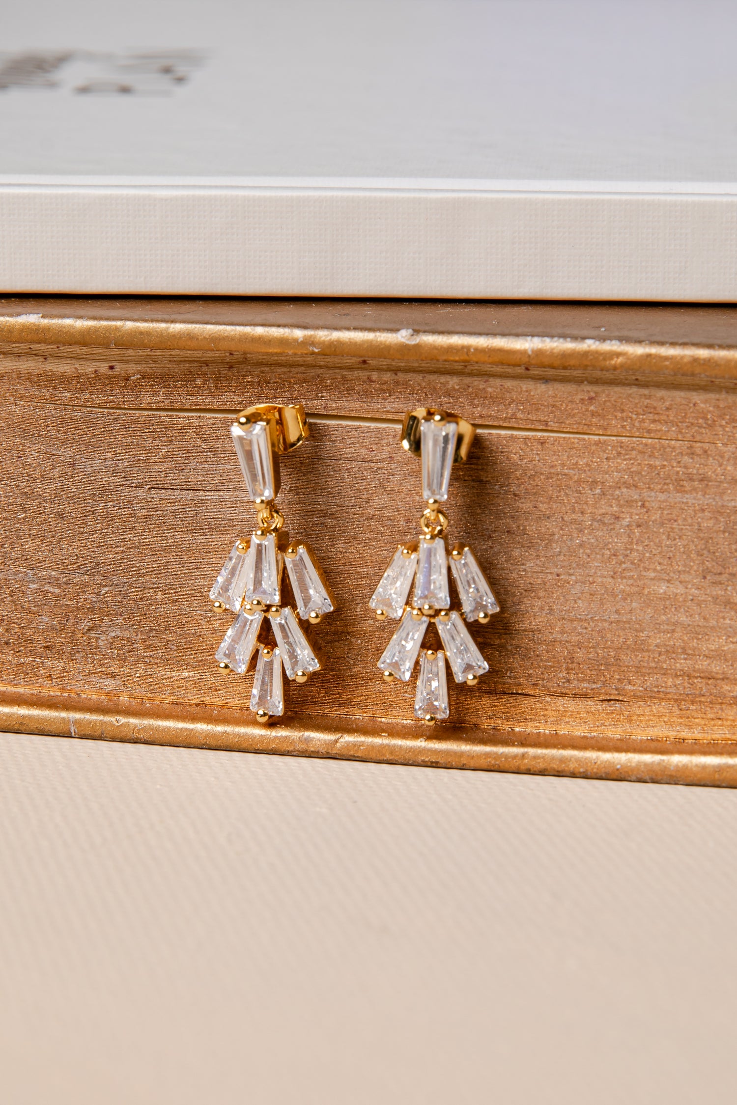 Pair of diamond earrings on a wooden surface