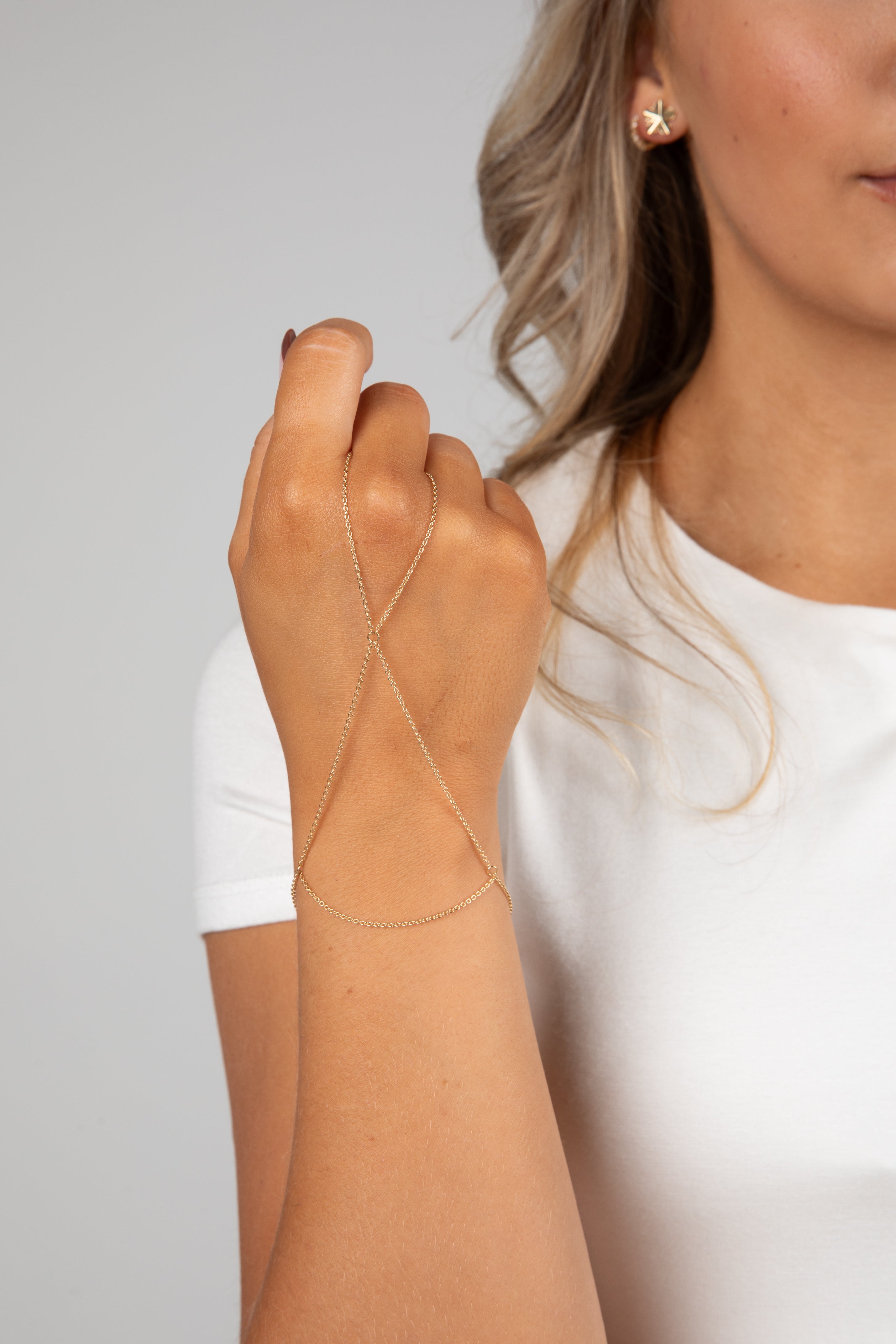 Woman wearing a beige arm sleeve against a gray background