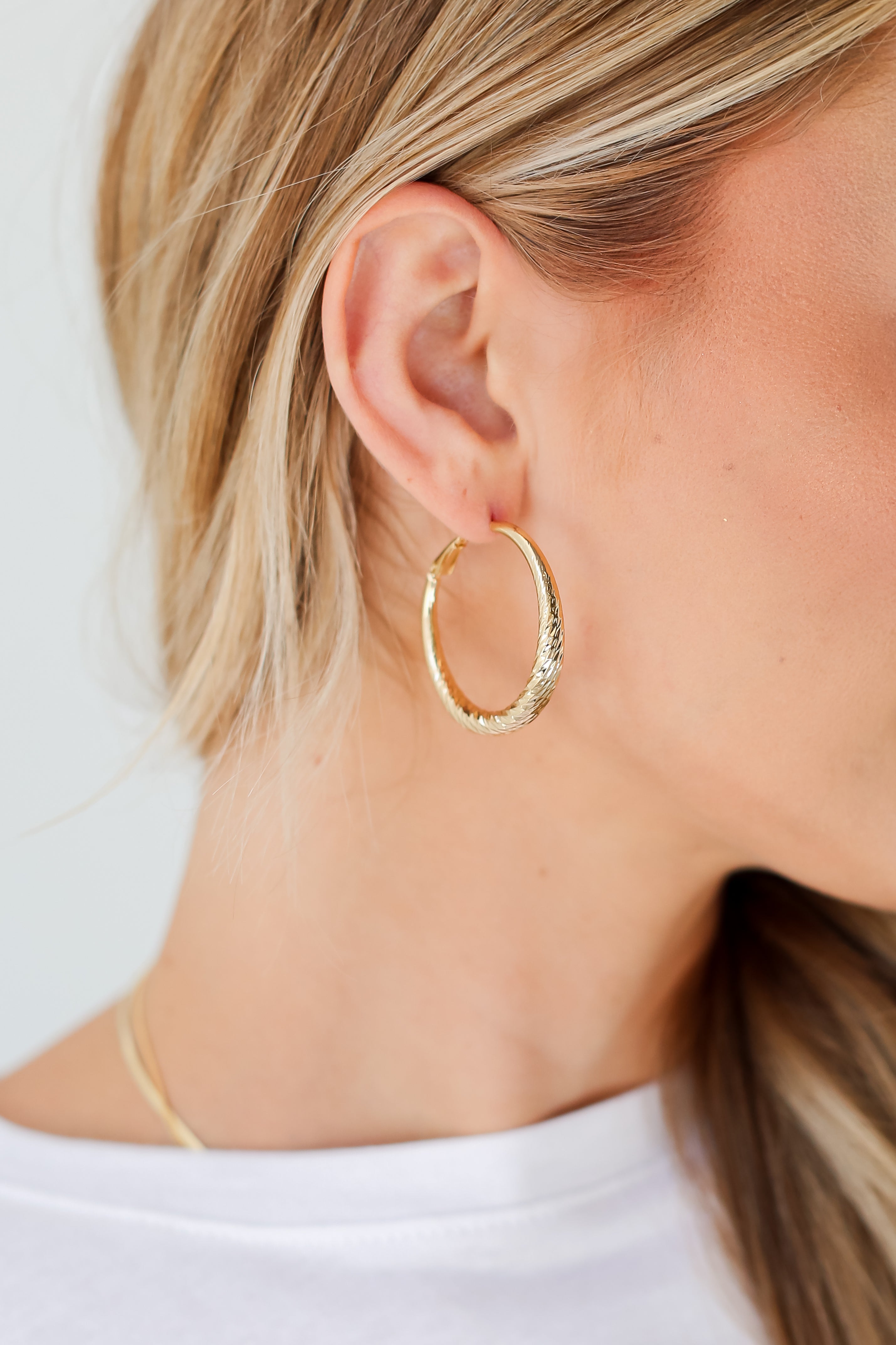 Gold Twisted Hoop Earrings on model