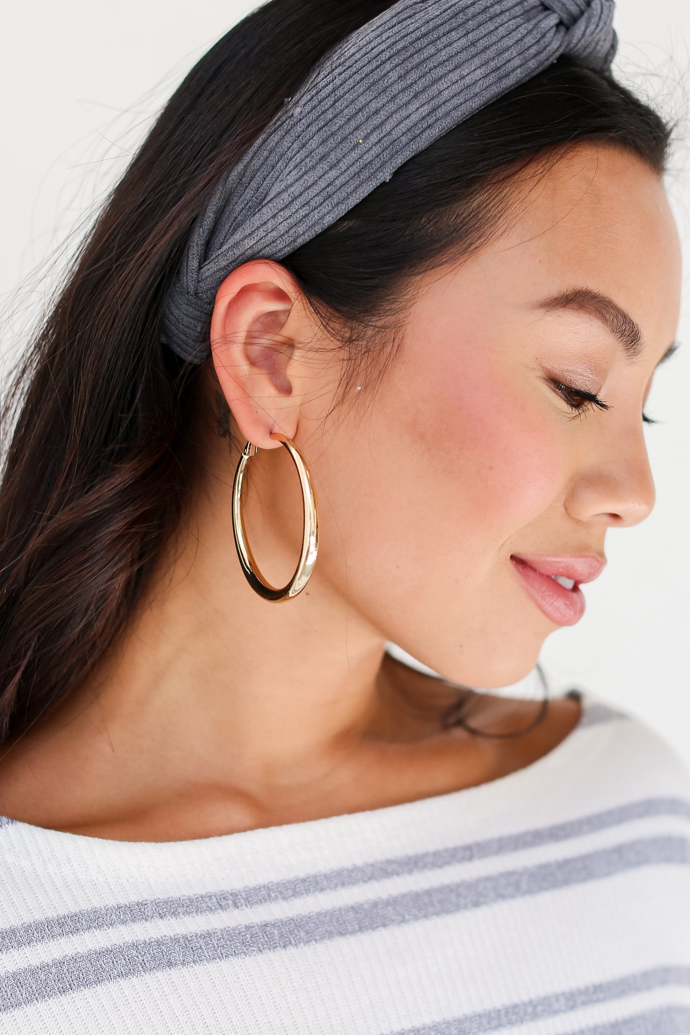 model wearing Gold Hoop Earrings
