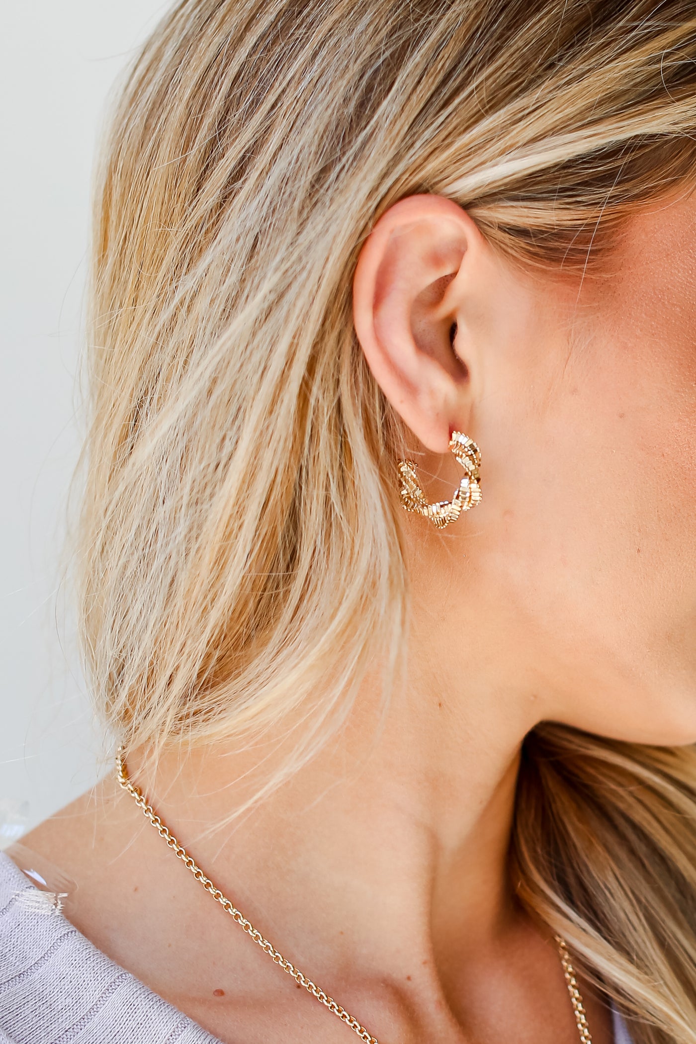 Gold Twisted Hoop Earrings on model