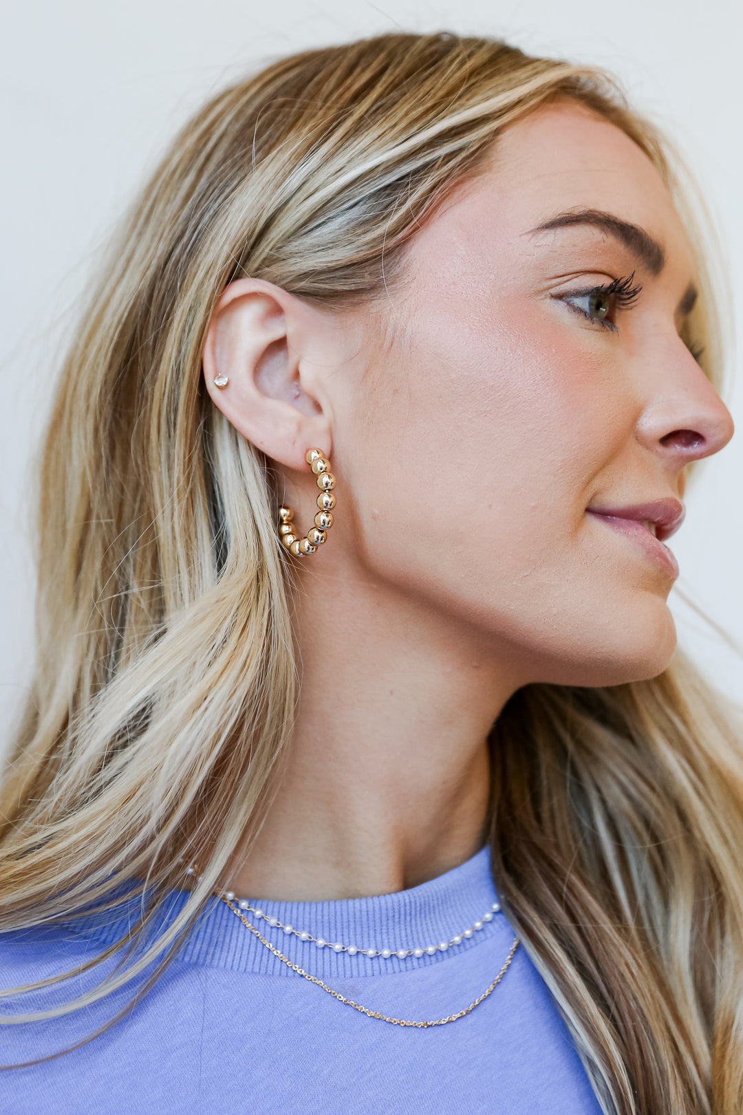 Gold Ball Hoop Earrings on model