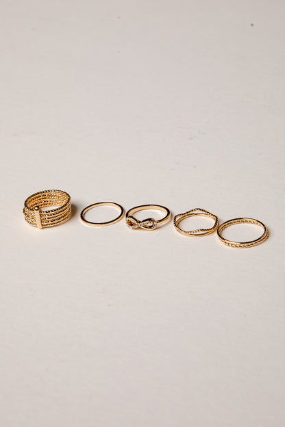 Set of gold rings on a light gray background