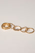 Set of gold rings on a light gray background