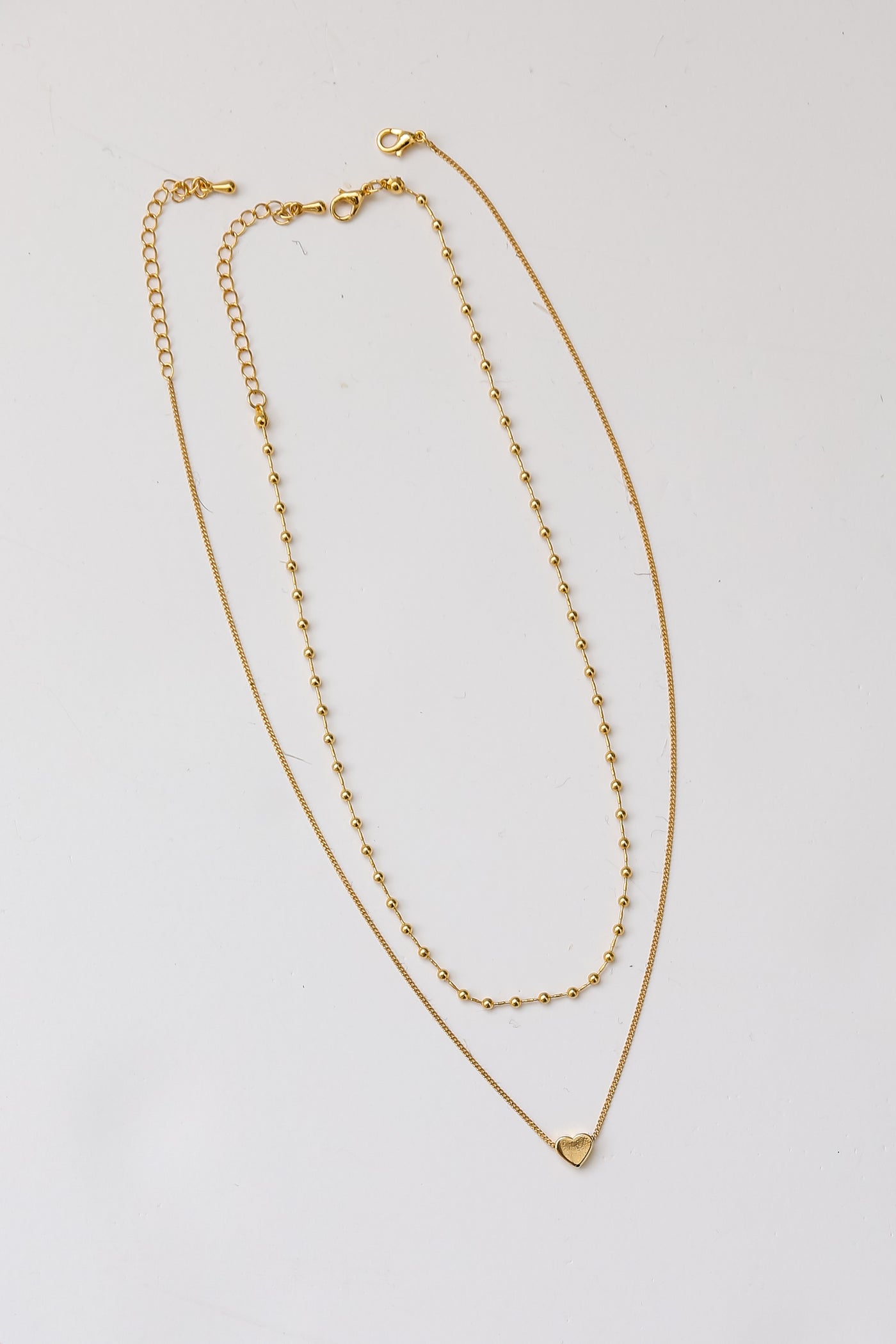 Gold Heart Charm Layered Necklace flat lay