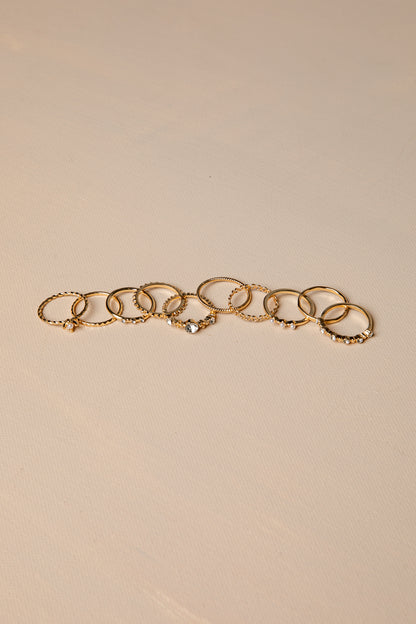Gold rings with multiple rings on a beige background
