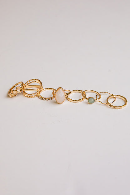 Gold bracelet with stones on a light gray background