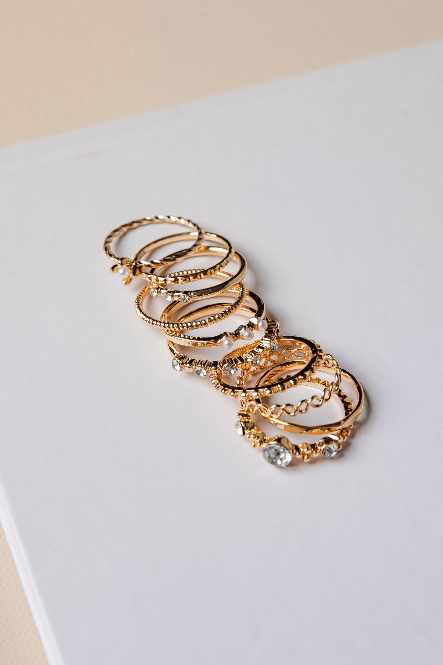 Set of gold hoop earrings on a light gray surface