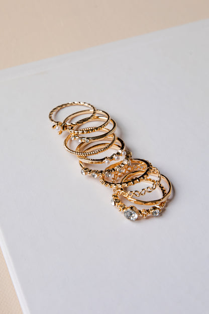 Set of gold hoop earrings on a light gray surface